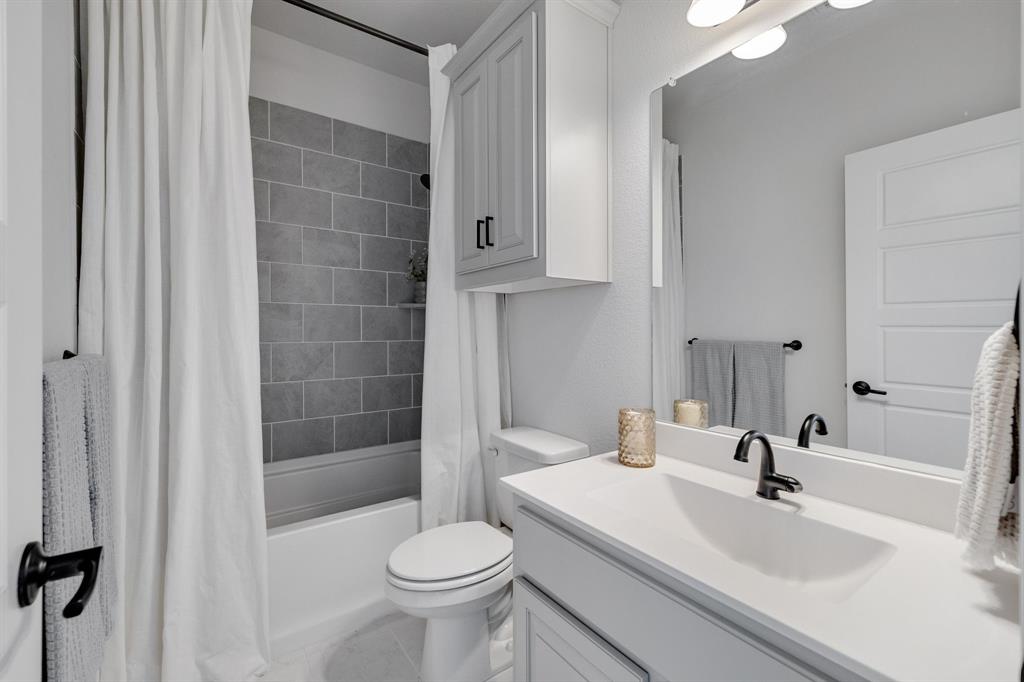 707 Soprano Drive Forney, TX 75126 - Photo 26 of 37 a bathroom with a sink a toilet and shower
