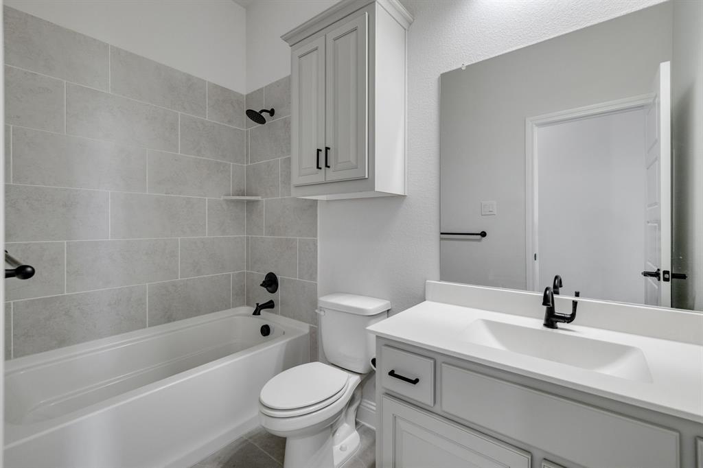 707 Soprano Drive Forney, TX 75126 - Photo 29 of 37 a bathroom with a sink a toilet and a bathtub