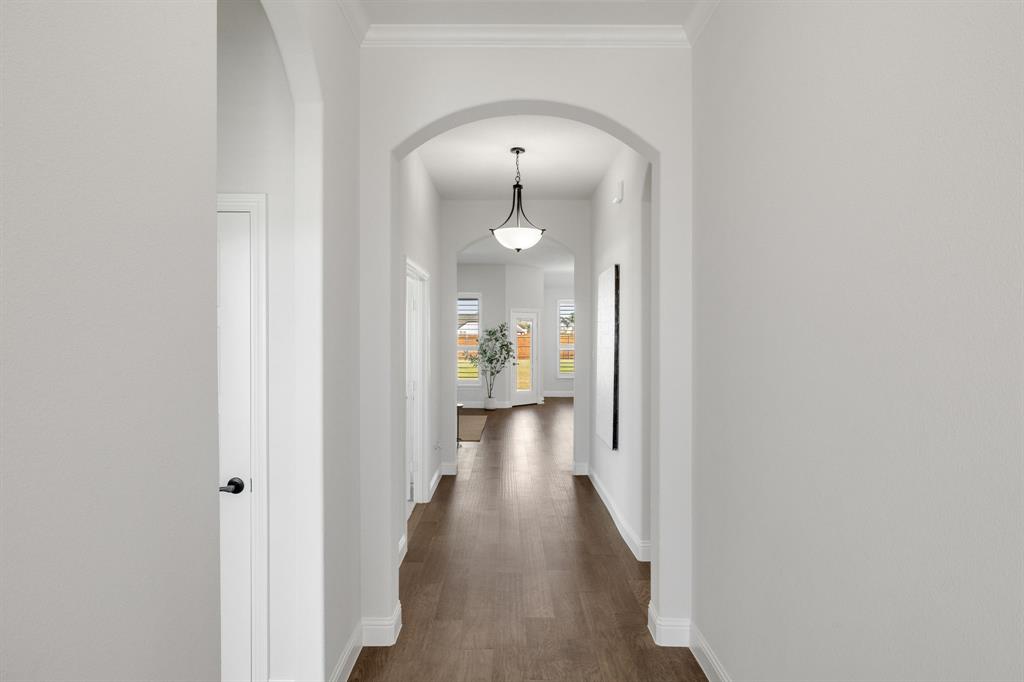 707 Soprano Drive Forney, TX 75126 - Photo 3 of 37 a view of a hallway with wooden floor and a bathroom