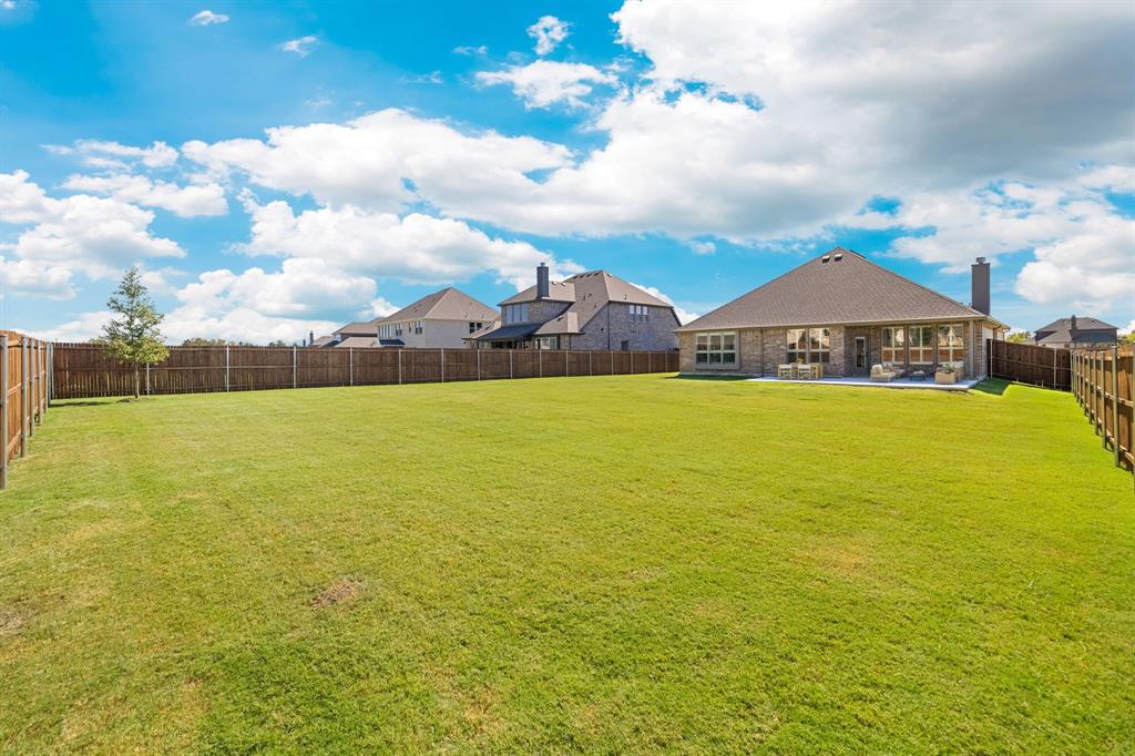 707 Soprano Drive Forney, TX 75126 - Photo 32 of 37 a view of a swimming pool with lawn chairs and large trees