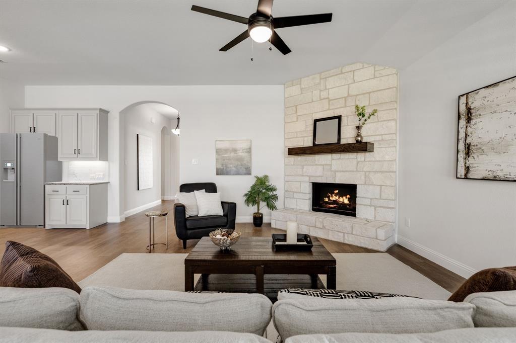 707 Soprano Drive Forney, TX 75126 - Photo 9 of 37 a living room with furniture and a fireplace