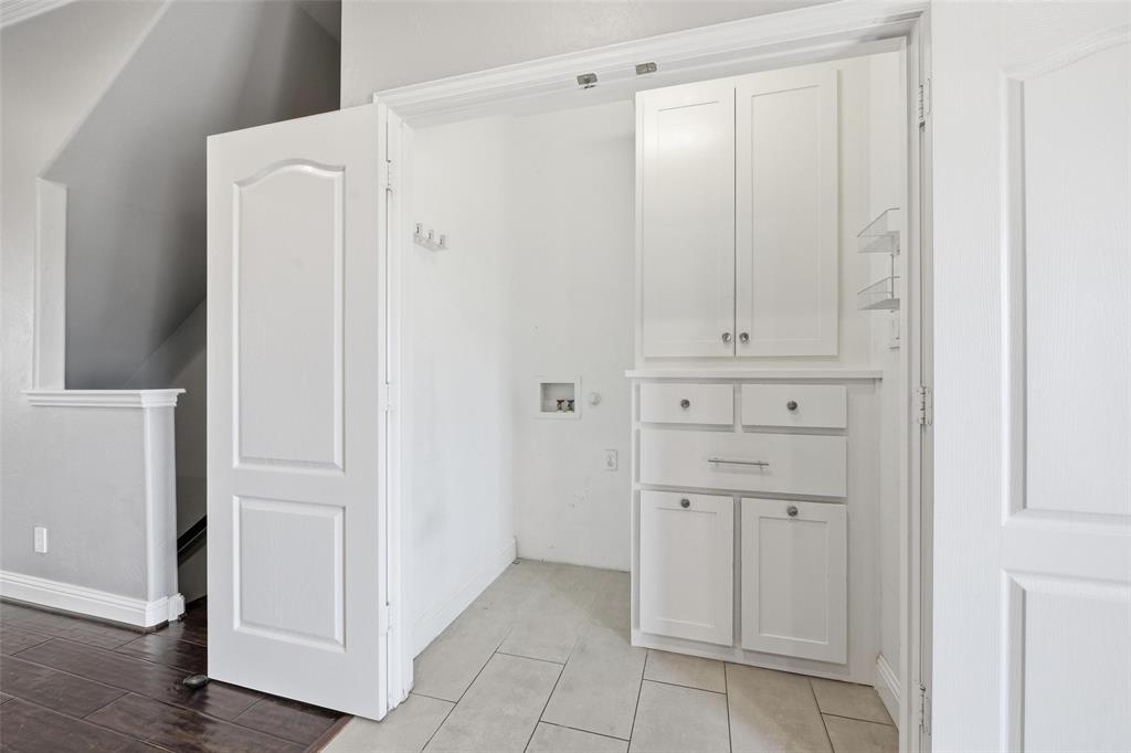 722 East 1st Street Fort Worth, TX 76102 - Photo 11 of 30 Designed for efficiency, the laundry area accommodates a stackable washer and dryer and includes ample cabinetry for storage.