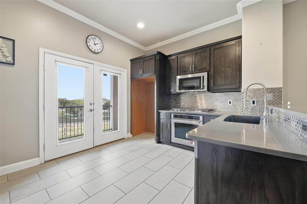 722 East 1st Street Fort Worth, TX 76102 - Photo 7 of 30 Let the sun shine in to your bright kitchen courtesy of your private balcony.