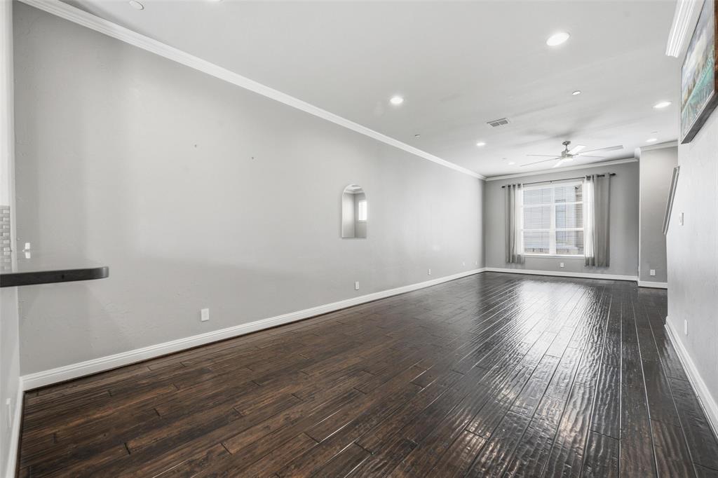 722 East 1st Street Fort Worth, TX 76102 - Photo 8 of 30 Dominated by hand-scraped hardwood flooring, this spacious area can serve as one large living space or be arranged for multiple purposes.