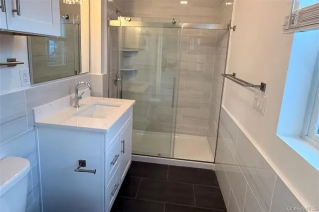 a bathroom with a sink a mirror and a shower