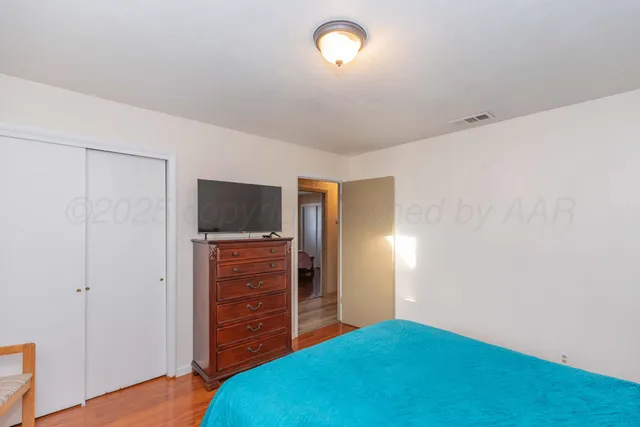 a bed room with a bed and a walk in closet