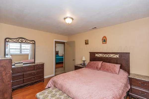 a bedroom with a bed and a dresser