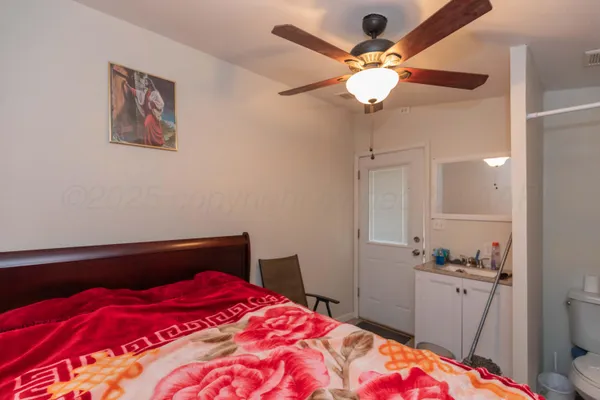 a bedroom with a bed and a chandelier