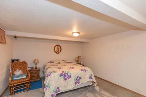 a bedroom with a bed and dresser