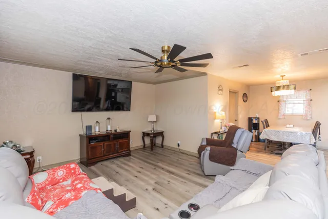 a kitchen with granite countertop a sink a stove and cabinets