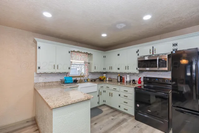 a bedroom with a bed and a lamp with the dresser