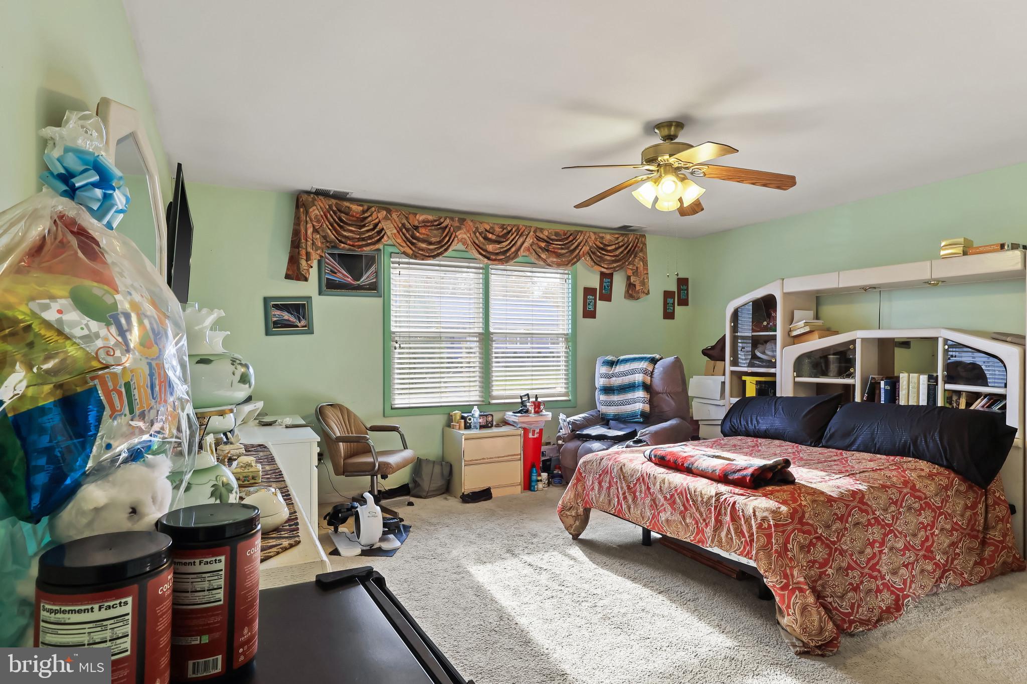 32 Ruby Street Springfield, NJ 07081 - Photo 20 of 31 a bedroom with a bed gym equipment and a large window