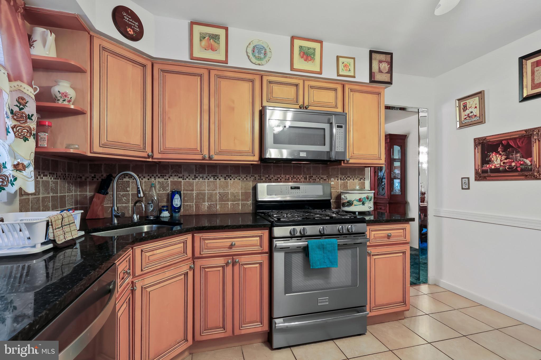32 Ruby Street Springfield, NJ 07081 - Photo 10 of 33 a kitchen with stainless steel appliances granite countertop a stove top oven a sink dishwasher and cabinets with wooden floor