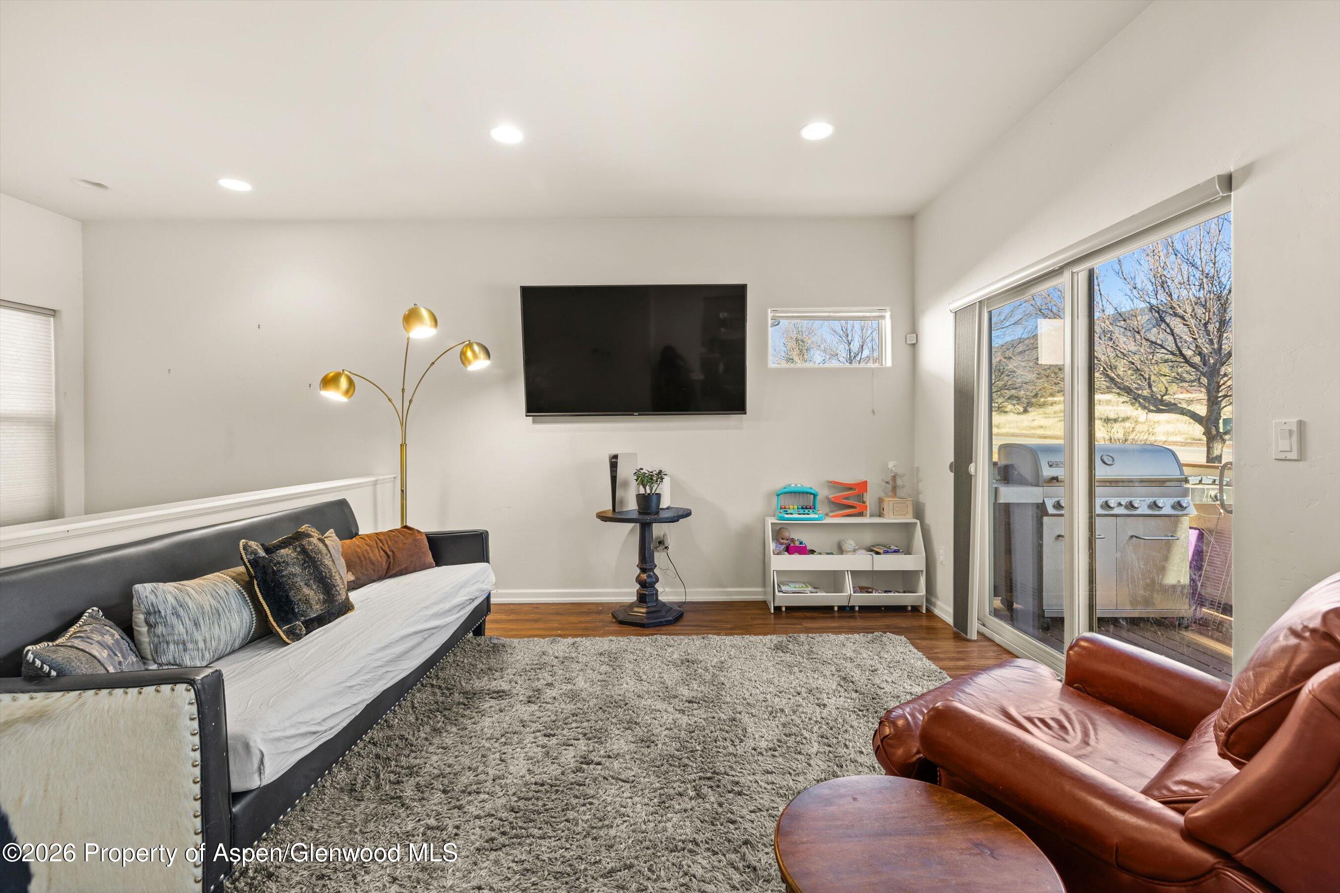 66 Castle Ridge Drive New Castle, CO 81647 - Photo 3 of 23 a living room with furniture and a flat screen tv