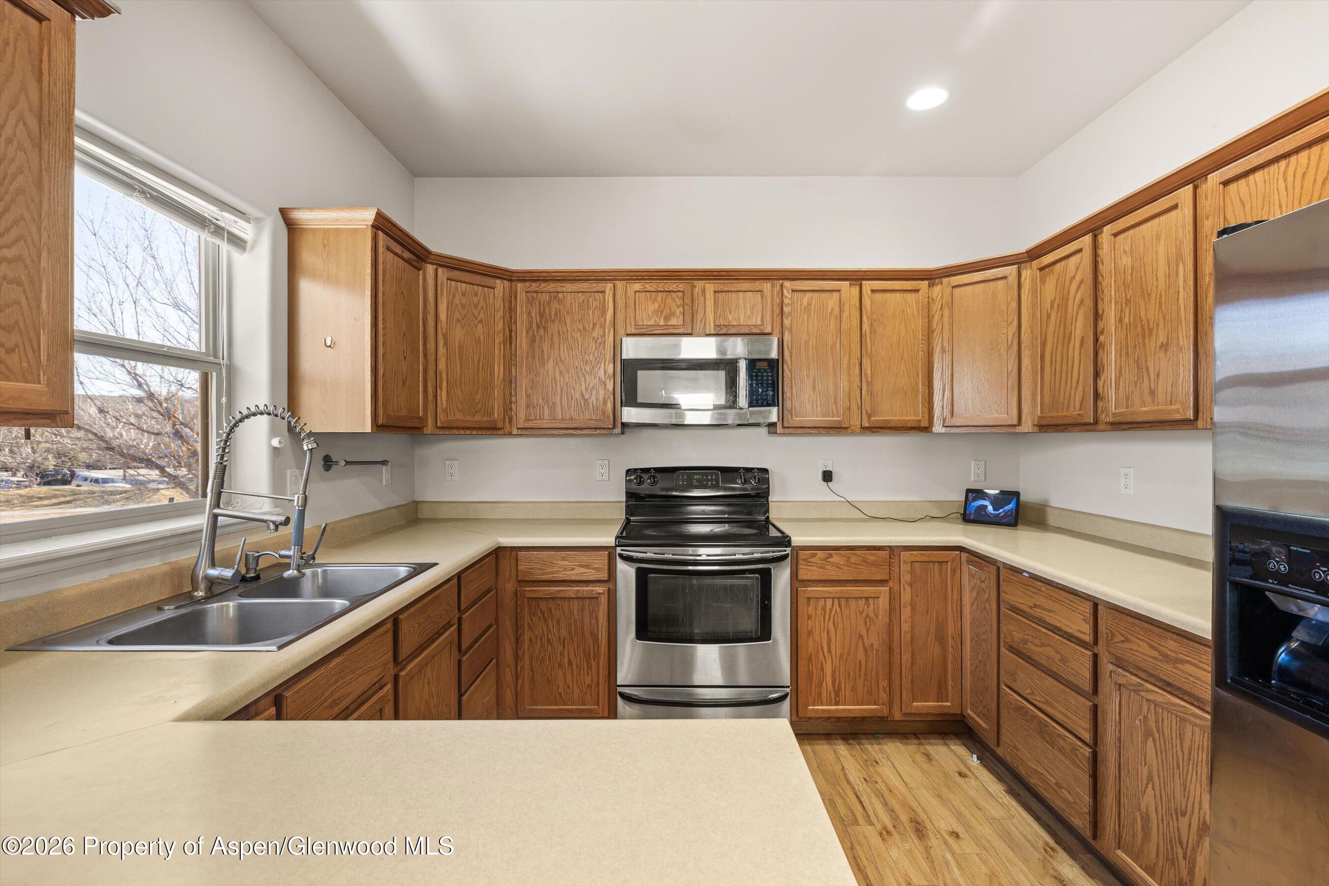 66 Castle Ridge Drive New Castle, CO 81647 - Photo 8 of 23 a kitchen with stainless steel appliances granite countertop a sink stove and microwave
