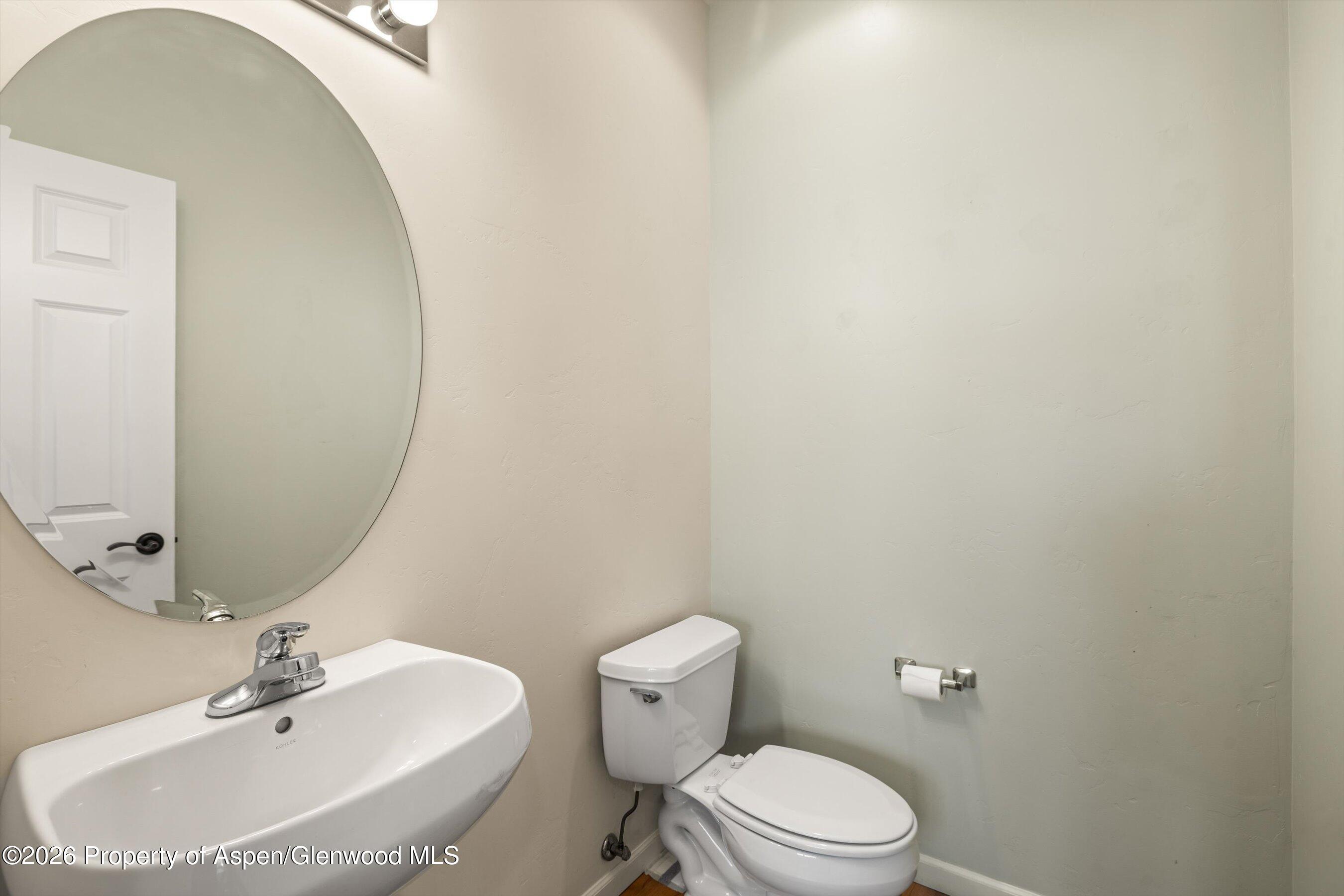 66 Castle Ridge Drive New Castle, CO 81647 - Photo 9 of 23 a bathroom with a sink a toilet and mirror