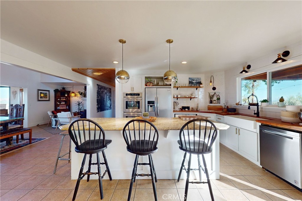 8560 Warren Road Paso Robles, CA 93446 - Photo 19 of 74 a view of a dining room with furniture and chandelier