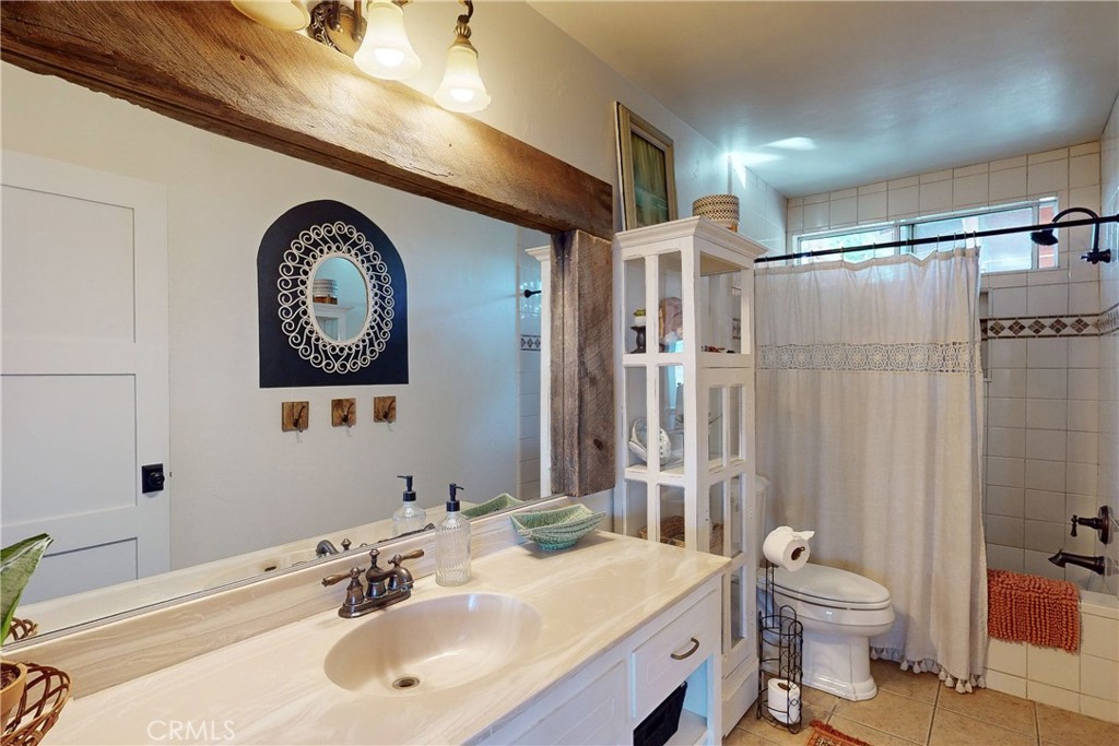 8560 Warren Road Paso Robles, CA 93446 - Photo 22 of 74 a bathroom with a toilet a sink and a mirror