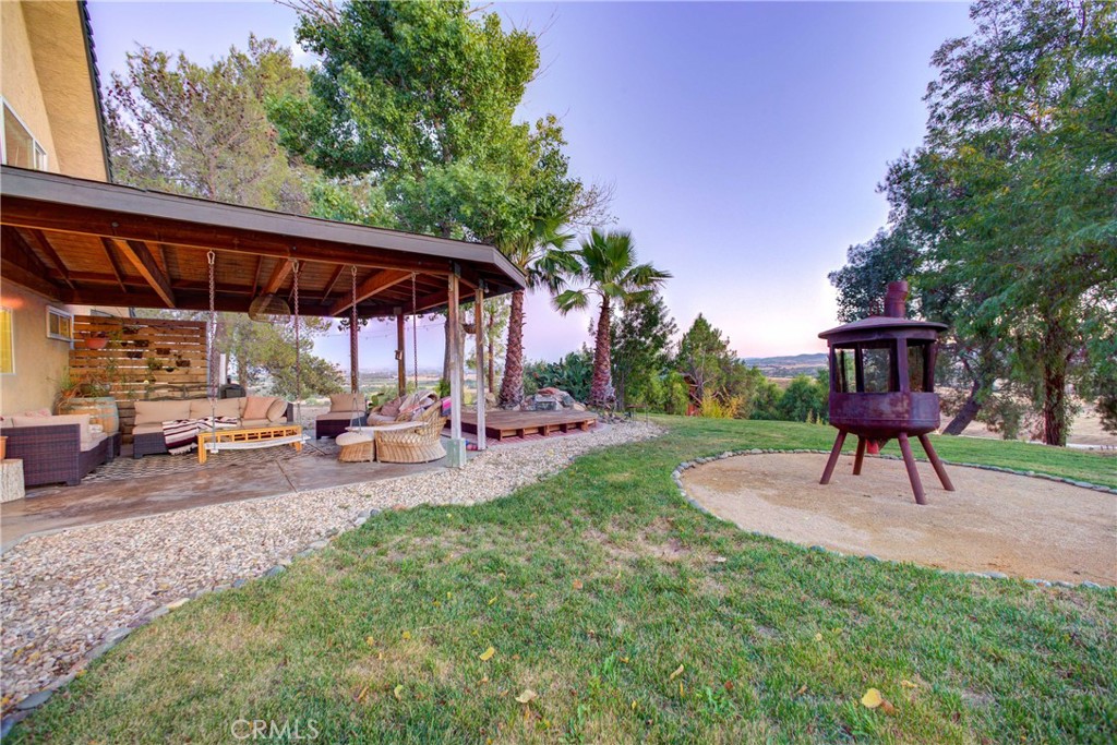 8560 Warren Road Paso Robles, CA 93446 - Photo 33 of 74 a view of a backyard with table and chairs under an umbrella