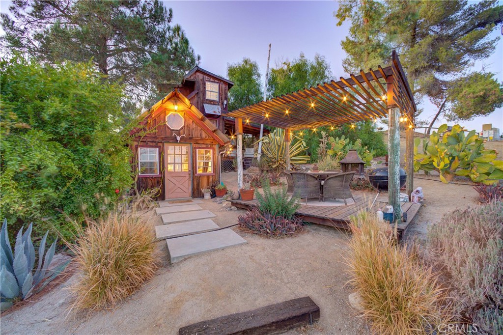 8560 Warren Road Paso Robles, CA 93446 - Photo 36 of 74 a front view of a house with a garden and tree