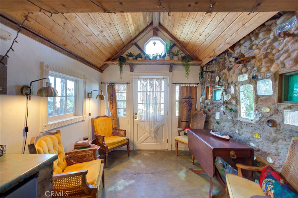 8560 Warren Road Paso Robles, CA 93446 - Photo 38 of 74 a living room with furniture a fireplace and a chandelier