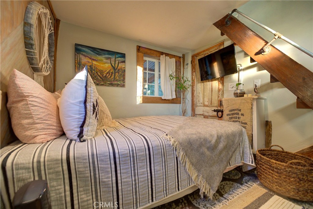 8560 Warren Road Paso Robles, CA 93446 - Photo 45 of 74 a bedroom with a bed and wooden floor