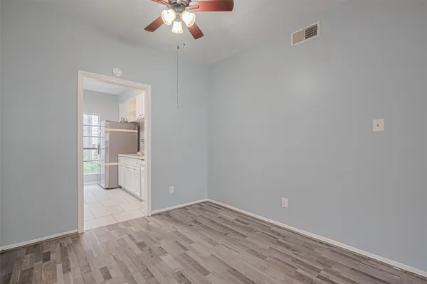 wooden floor in an empty room with a bathroom
