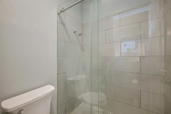 a bathroom with a toilet and shower