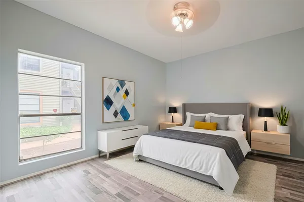 a bedroom with a bed and a window