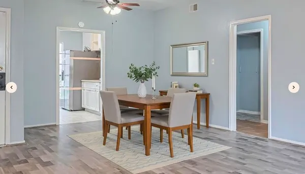 a dining room with furniture and window
