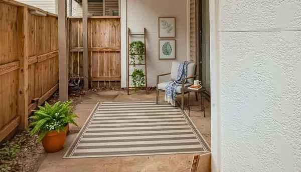 a view of a balcony with chairs and potted plants