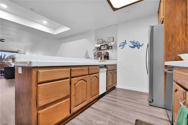 a kitchen with cabinets and a wooden floor