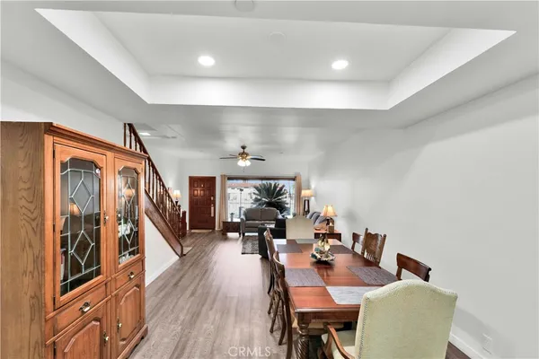 a dining room with furniture and wooden floor