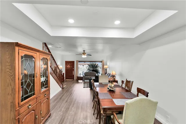 a dining room with furniture and wooden floor
