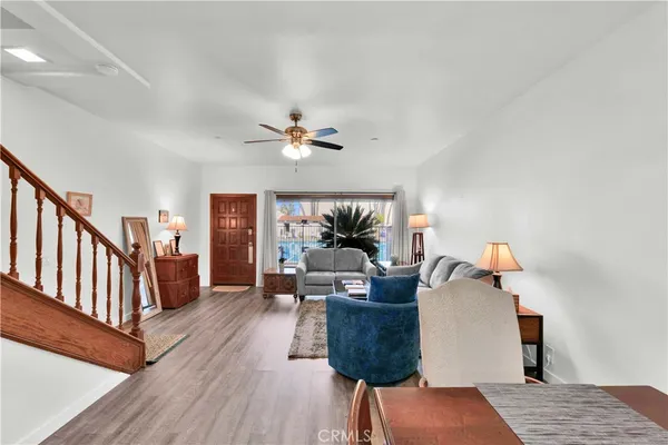 a living room with furniture and a chandelier