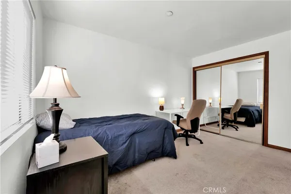 a living room with furniture a lamp and a window