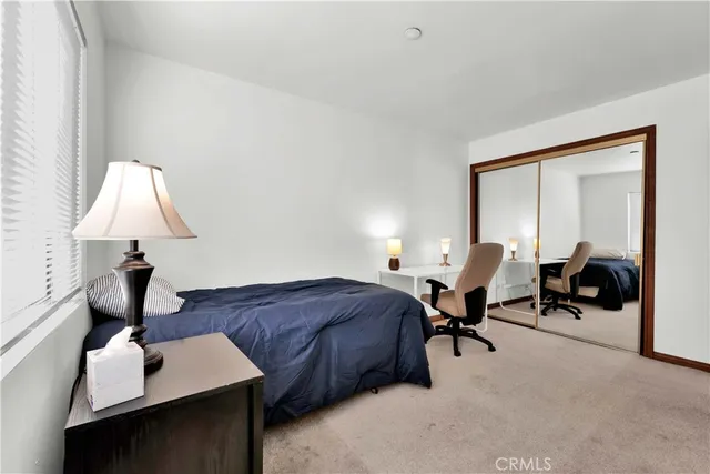 a living room with furniture a lamp and a window