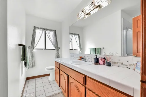 a bathroom with a sink a mirror and a shower