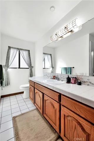 a spacious bathroom with a double vanity sink and a mirror