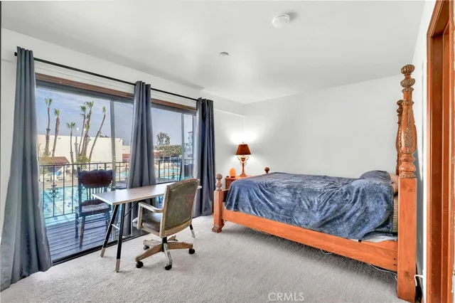 a living room with a bed furniture and a large window