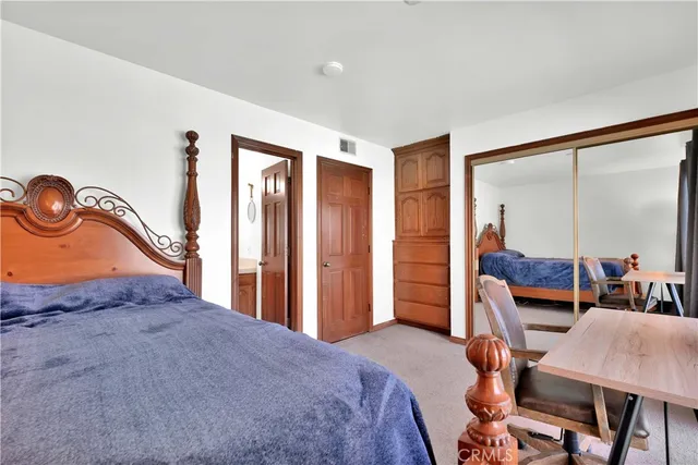 a bedroom with furniture and a large window