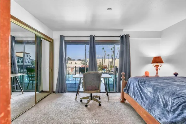 a bedroom with a bed and glass door