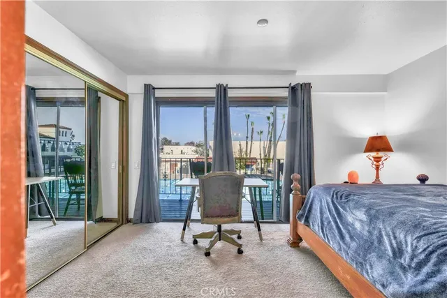 a bedroom with a bed and glass door