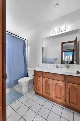 a spacious bathroom with a toilet sink and mirror