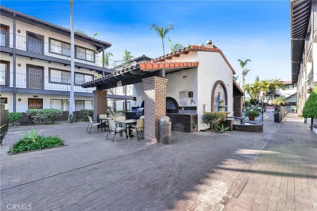 a man sitting on a bench in front of a building