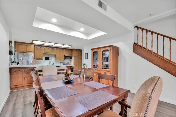 a dining room with furniture and wooden floor