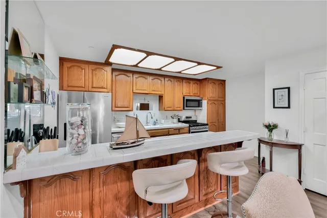 a kitchen with stainless steel appliances a sink and cabinets