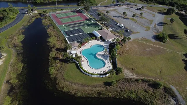 an aerial view of a house with a yard