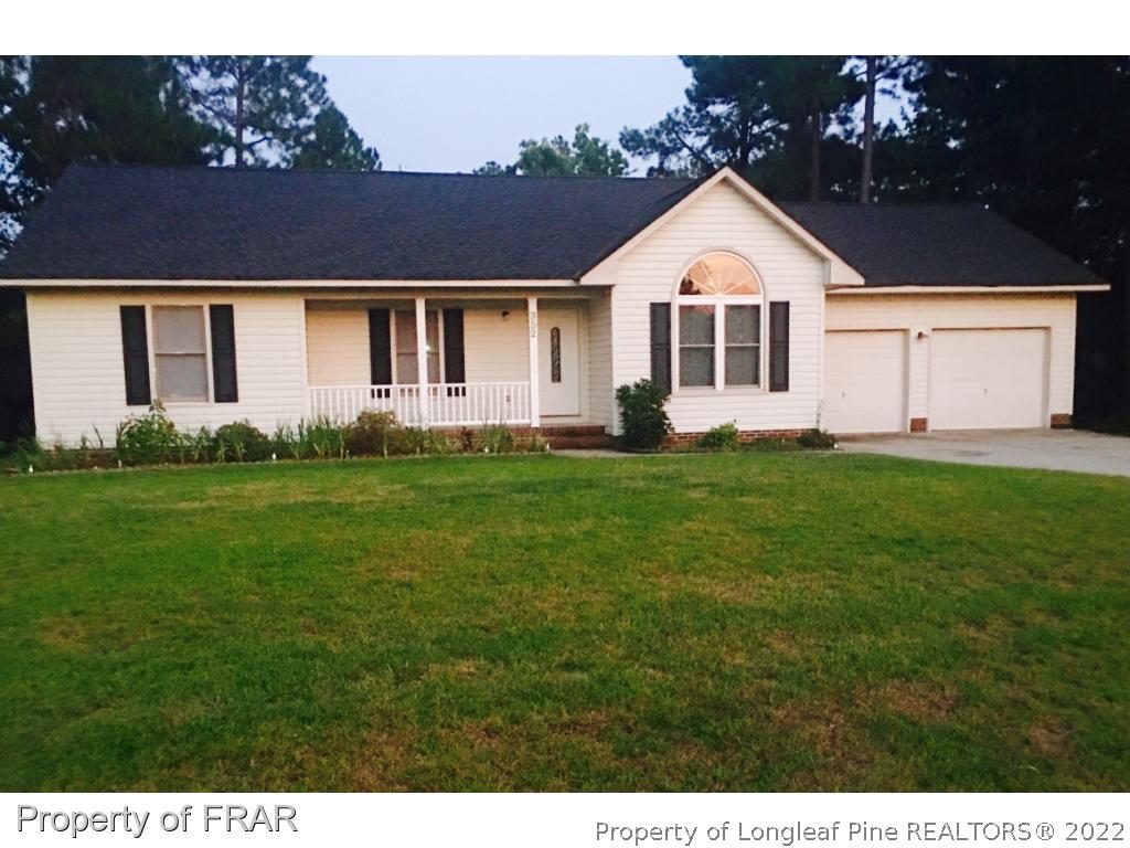352 Sawyer Road Cameron, NC 28326 - Photo 1 of 20 a front view of a house with a yard and garage