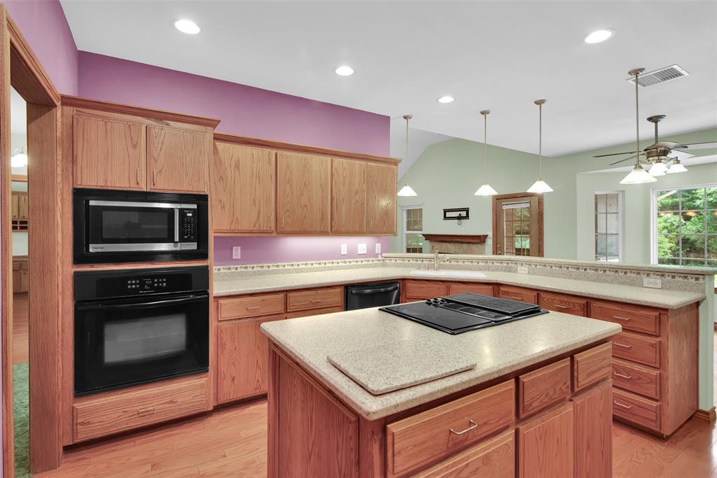 2255 Davy Lane Denison, TX 75020 - Photo 18 of 37 a kitchen with a stove a sink and a microwave